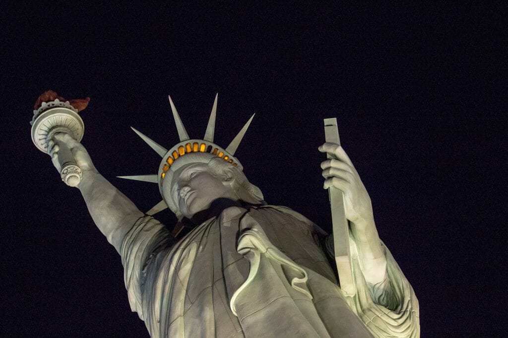 gay pride colors by night statue liberty