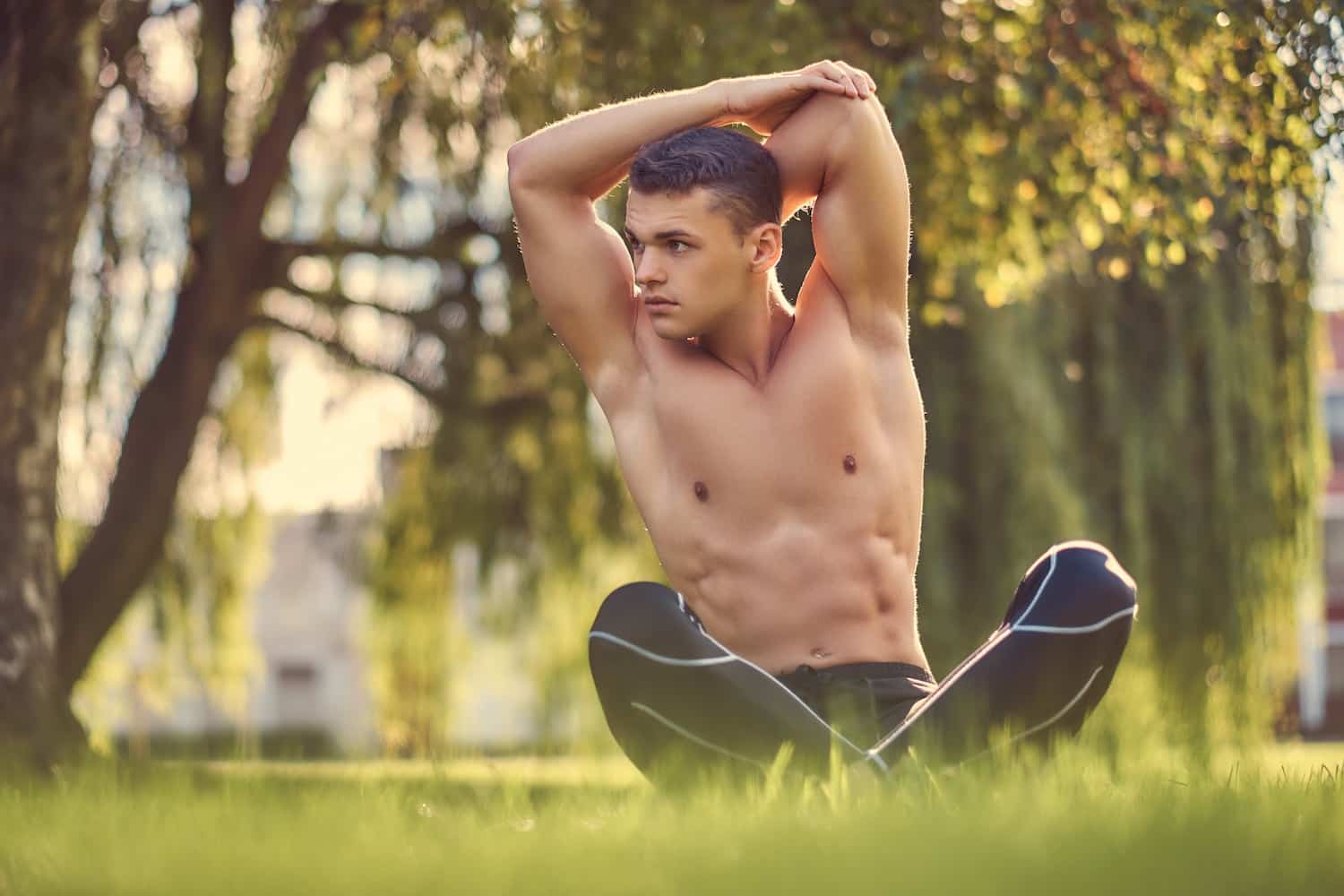 Athletic man with a muscular body poses in the gym, showing off his biceps  and back. The concept of a healthy lifestyle Stock Photo | Adobe Stock