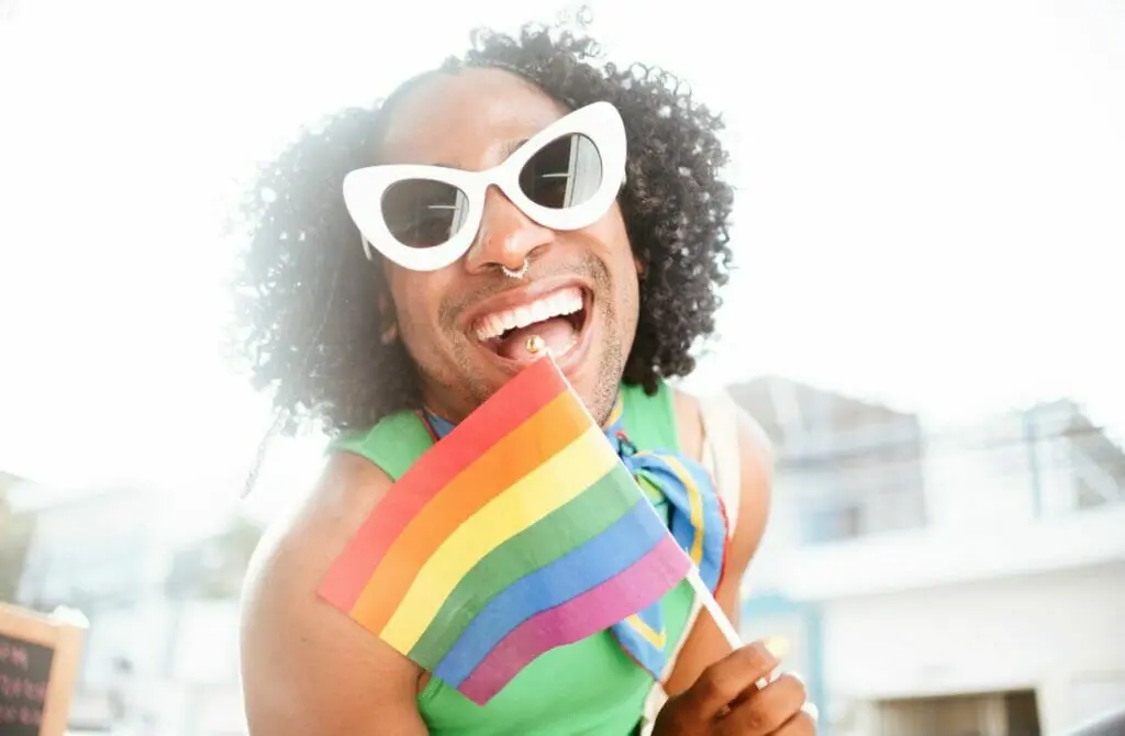 Queer Man Holding Rainbow Pride Flag